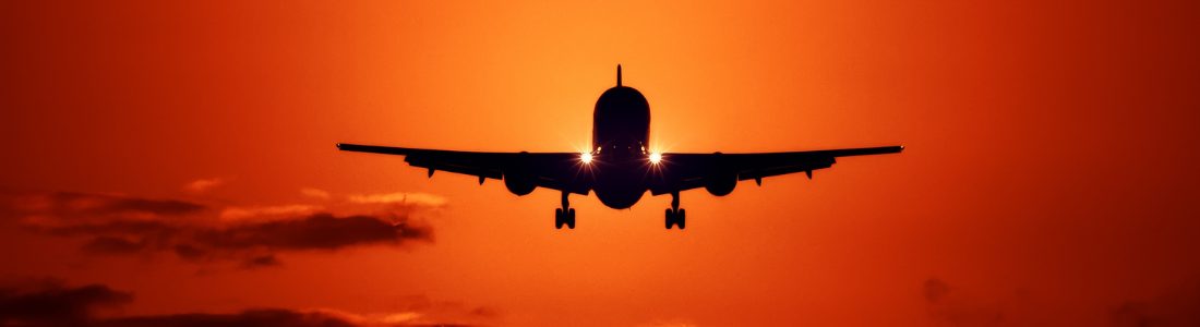 Plane with sunset behind